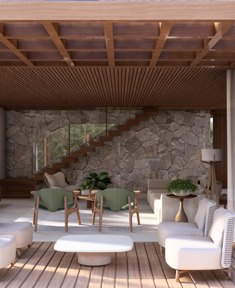 Estar aberto para o deck, com parede de pedra natural, poltronas claras e escada de madeira